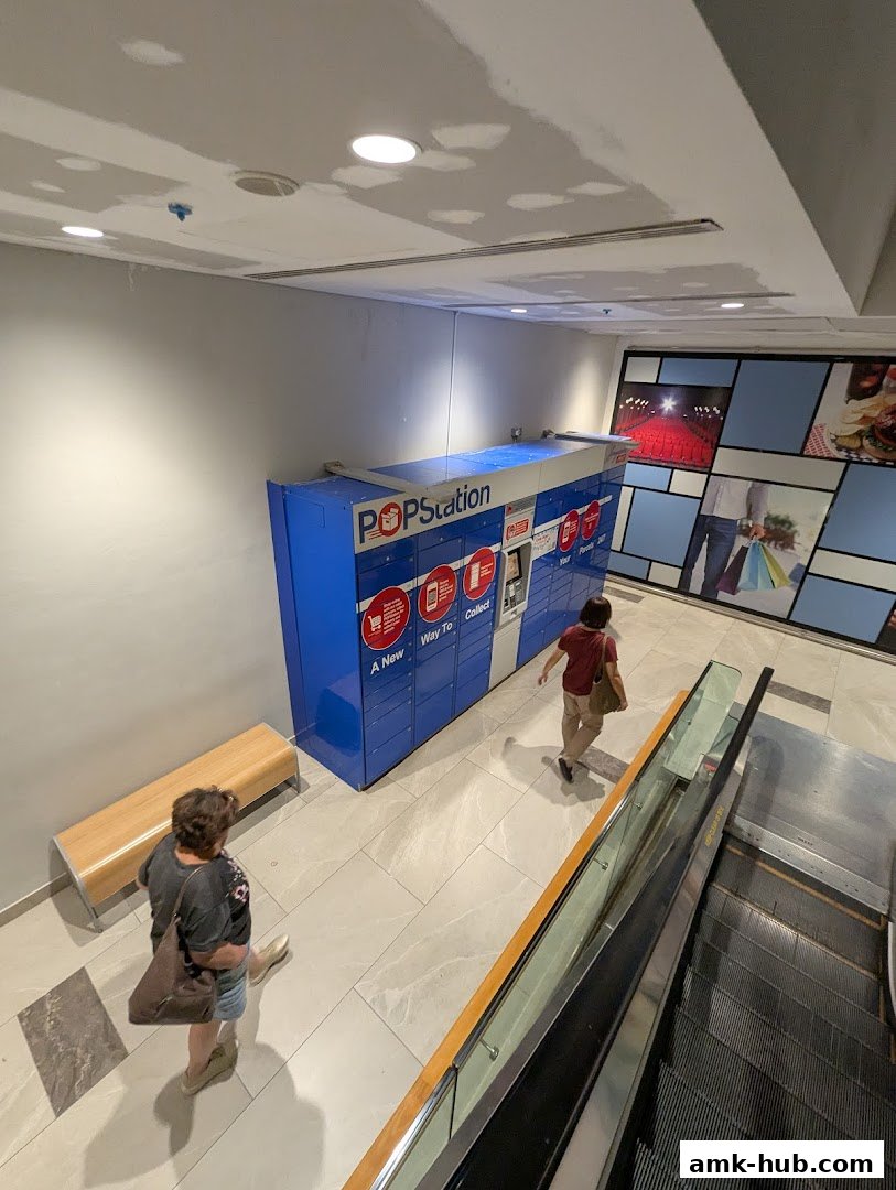 POPStation parcel lockers are located in a mall hallway with people walking by.