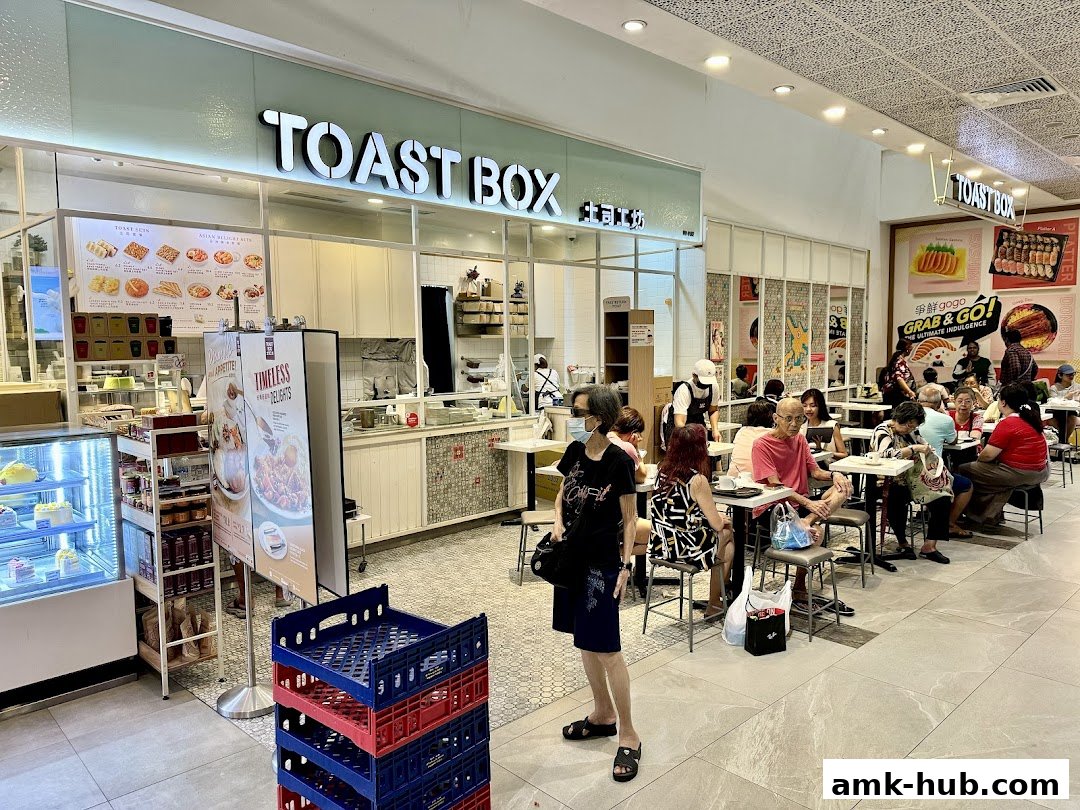 People dining at Toast Box, a popular eatery with a bright and inviting interior.
