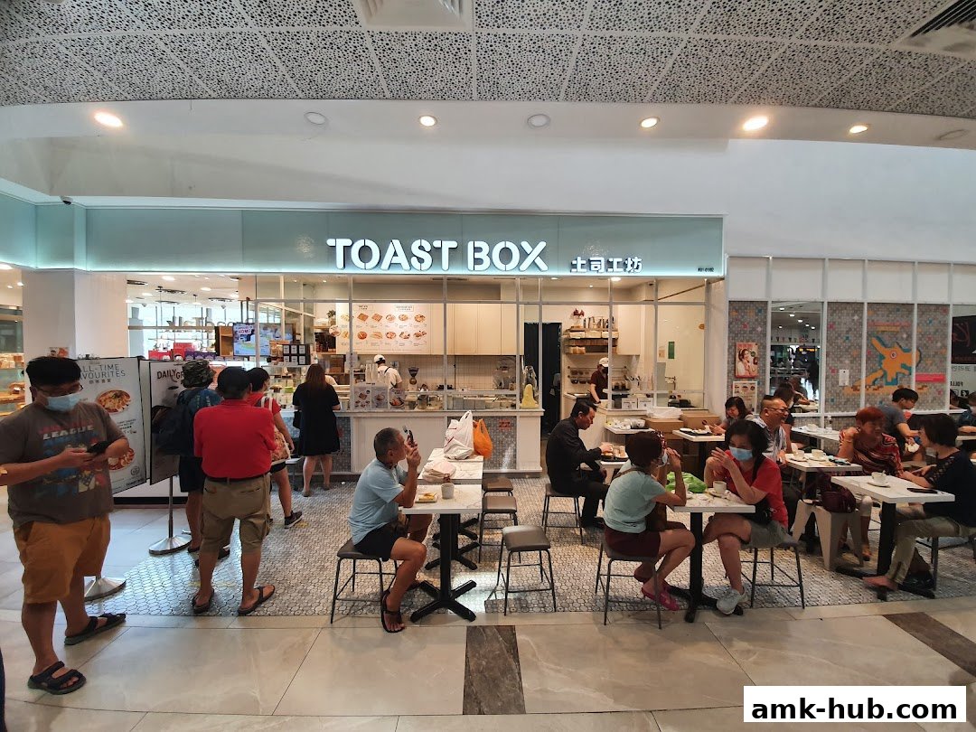 People dining at Toast Box AMK Hub, a popular eatery with a clean and modern interior.