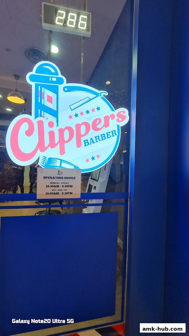 The entrance of Clippers Barber shop with its logo and operating hours displayed.