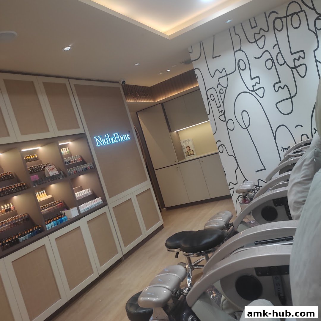 Interior of a modern nail salon with pedicure chairs and shelves stocked with nail polish.
