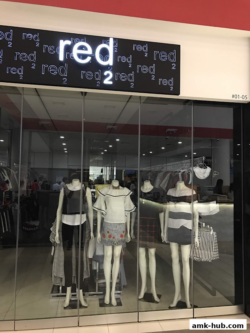 Mannequins display fashionable outfits in the window of the Red 2 clothing store.