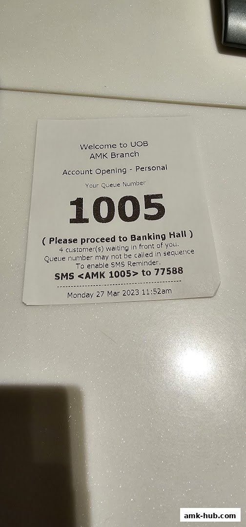 A queue number ticket for UOB AMK Branch, indicating account opening services.
