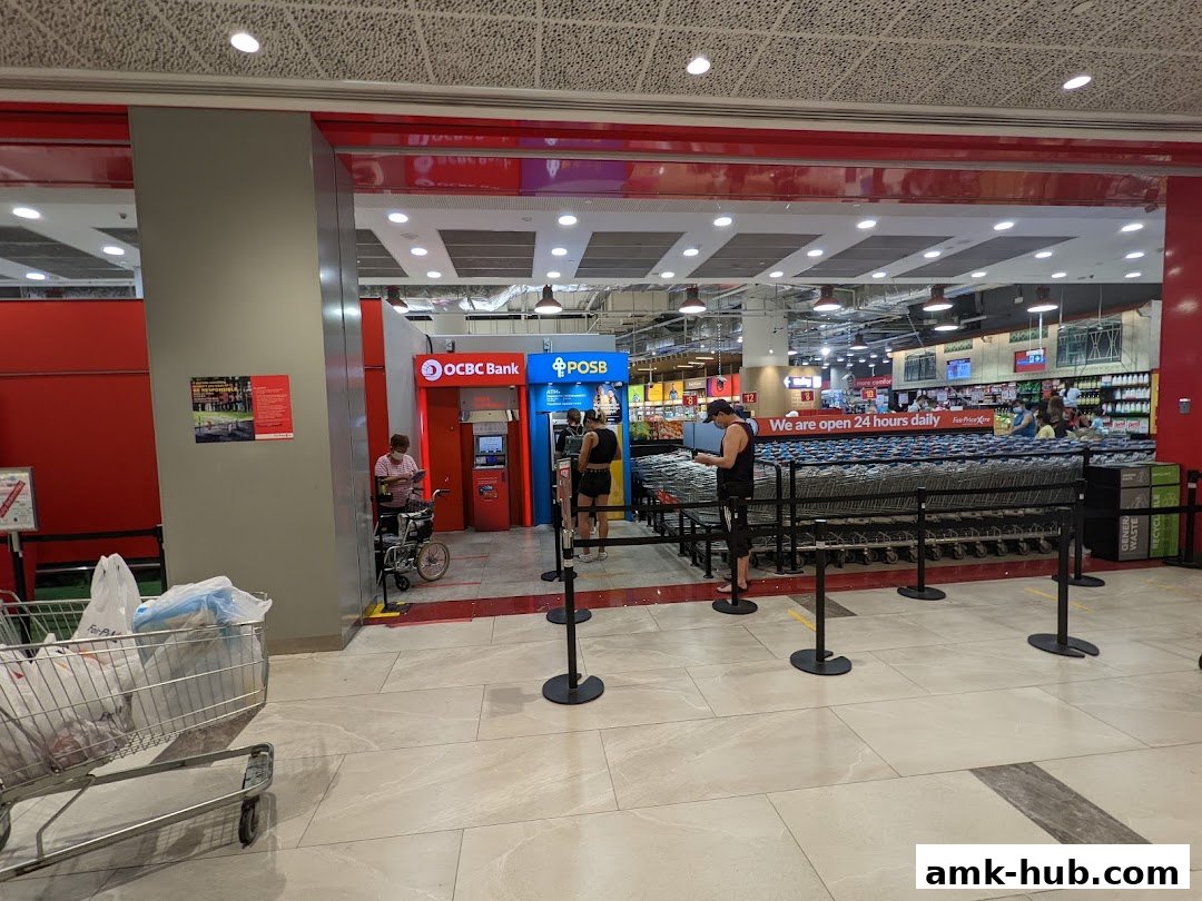 Entrance to Fairprice Xtra supermarket with OCBC ATM and POSB ATM visible.