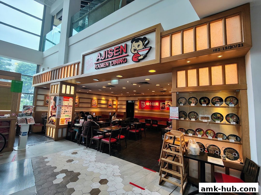 The exterior of Ajisen Ramen Dining, showcasing its entrance and display of ramen dishes.
