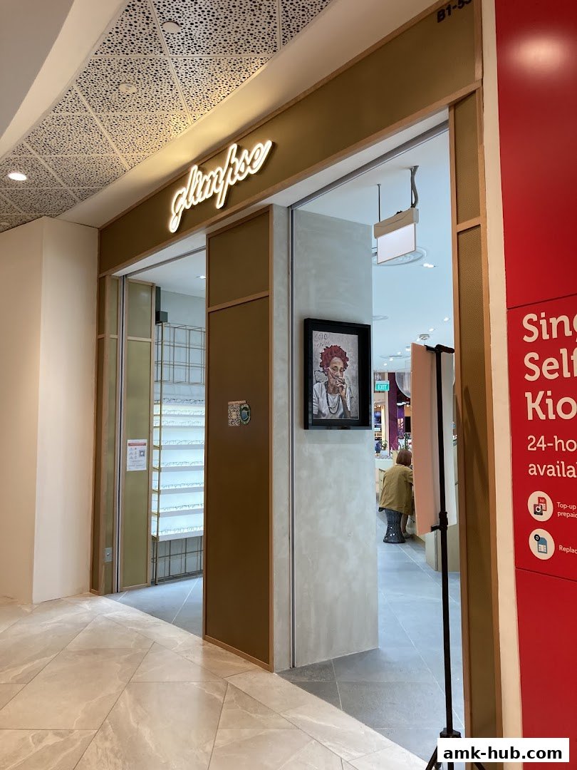 The entrance to the Glimpse shop, featuring a stylish neon sign and interior displays.