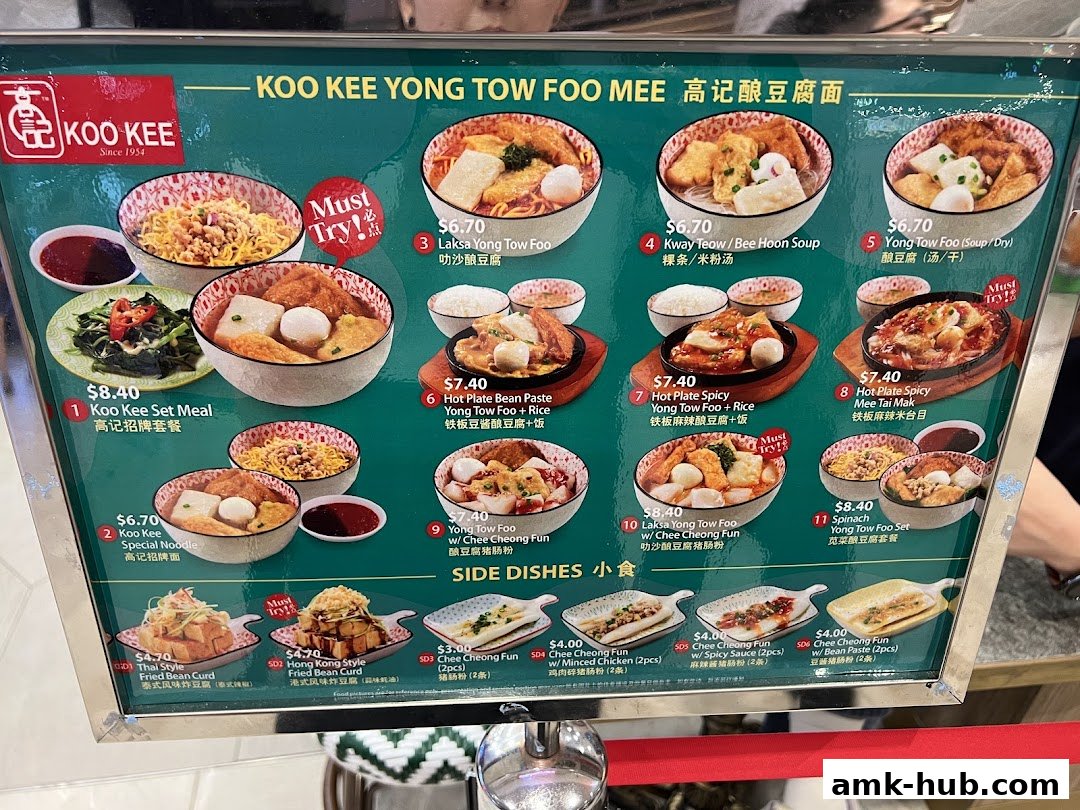 A menu board for Koo Kee Yong Tow Foo Mee, showcasing various noodle dishes and side dishes with prices.