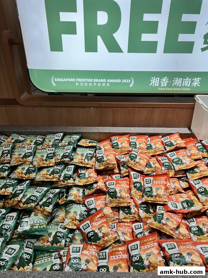 Bags of snacks are displayed with a sign indicating a Singapore Prestige Brand Award.