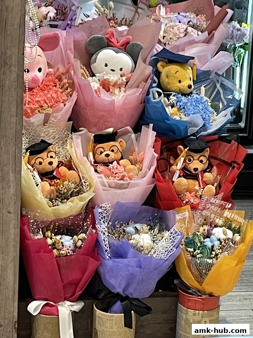 A display of colorful bouquets featuring plush toys like Winnie the Pooh and Minnie Mouse.