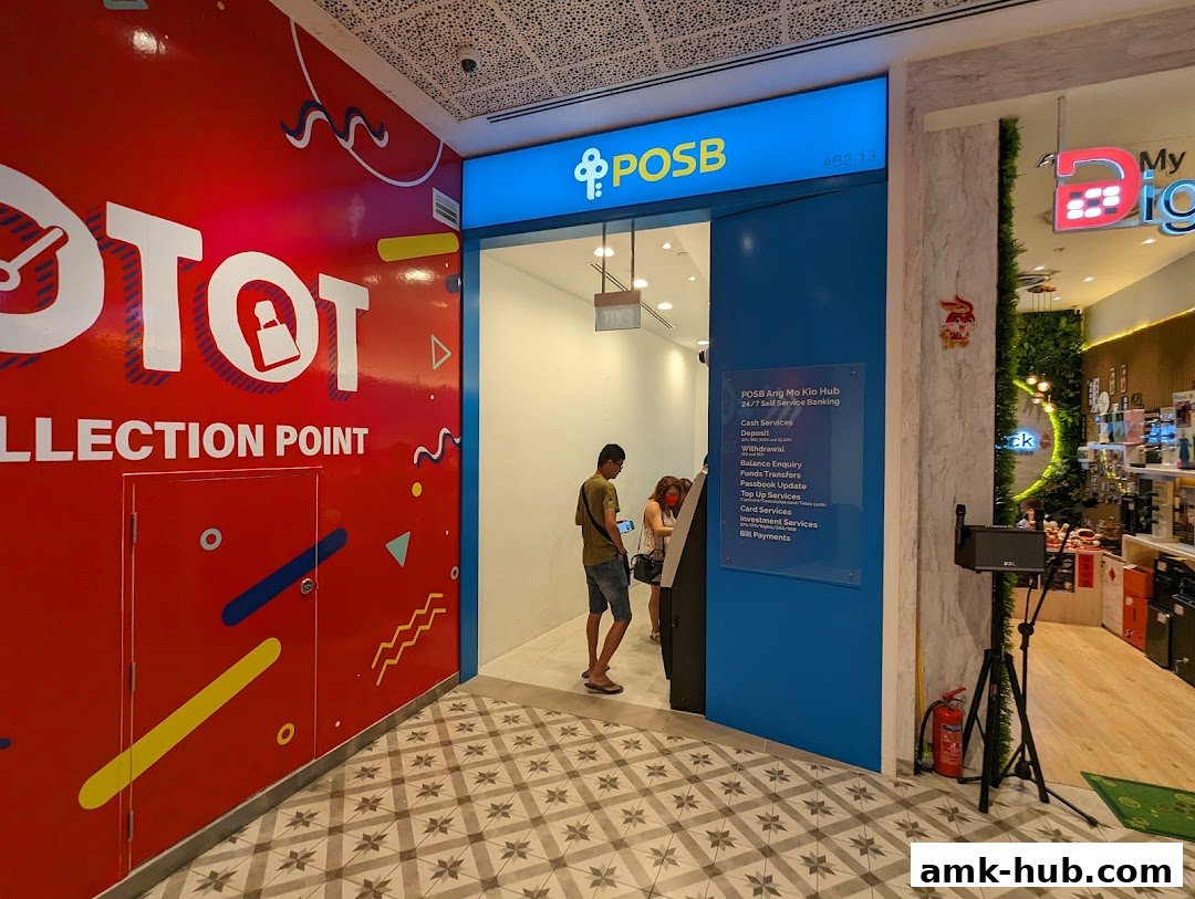 Entrance to a POSB bank branch with a collection point sign and people using an ATM.