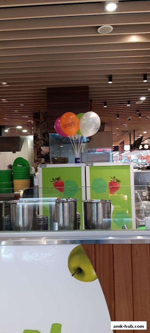 A counter area with stainless steel containers and colorful balloons above.
