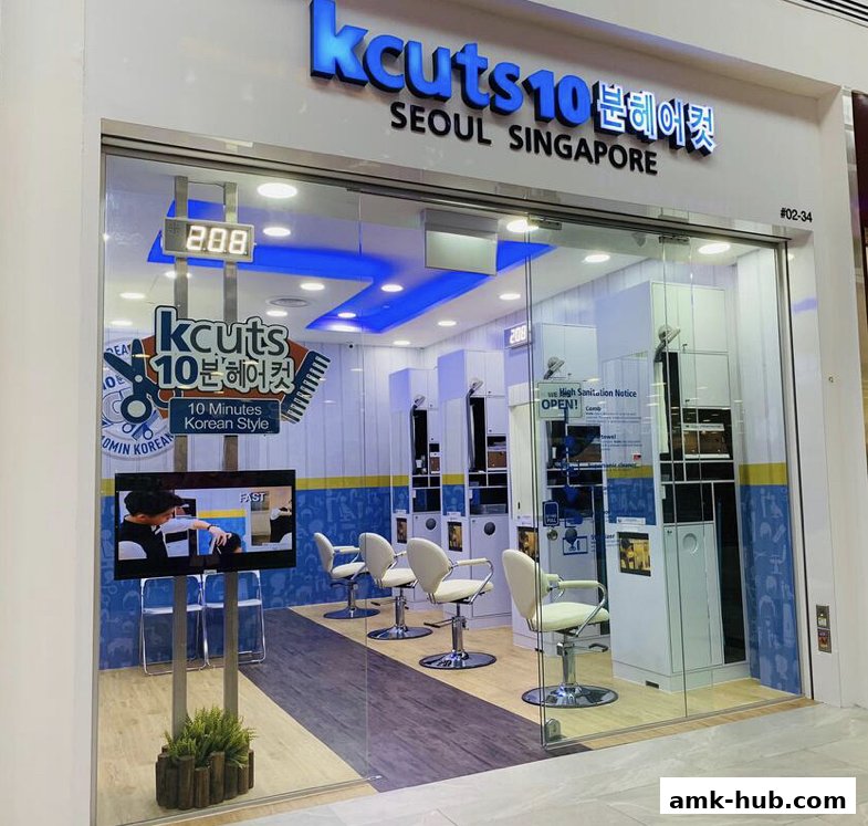The storefront of Kcuts hair salon, featuring a clean interior with styling chairs and a promotional screen.