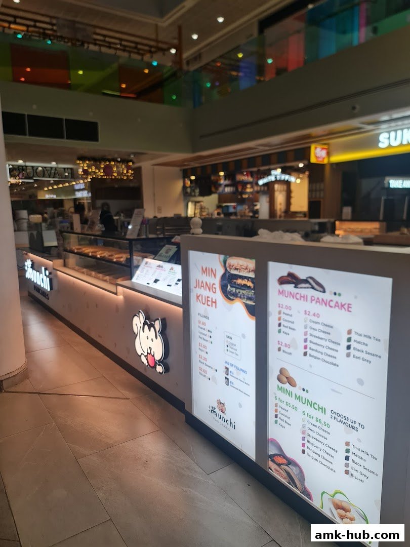 The Munchi Pancakes shop counter with illuminated menus displaying pancake options and fillings.