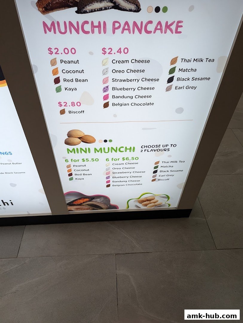 A menu board for Munchi Pancakes displaying various flavors and prices.