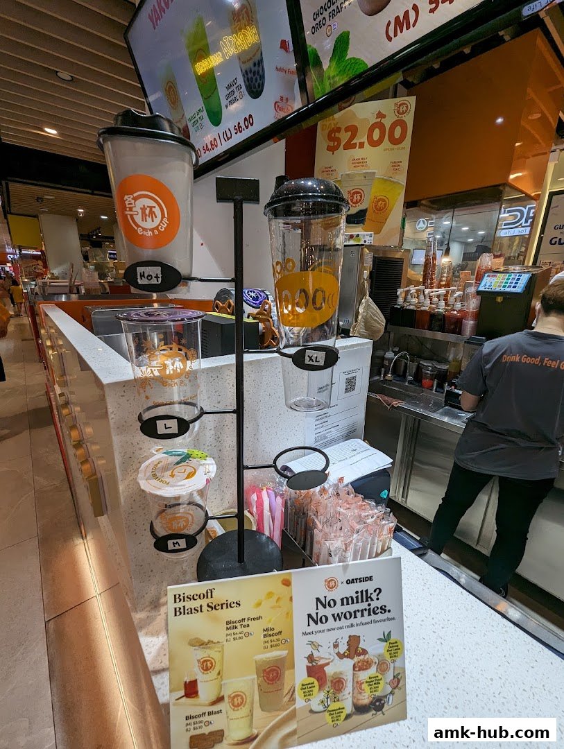 A display of drink cups and promotional flyers for a beverage shop.