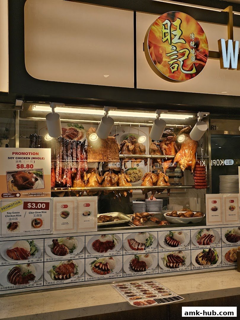 A food stall displaying various roasted meats like duck, chicken, and char siu, with a menu board and promotions.