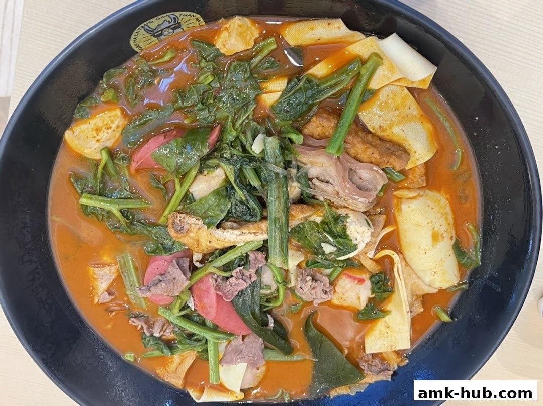A close-up overhead view of a steaming bowl of Mala Tang with various ingredients.