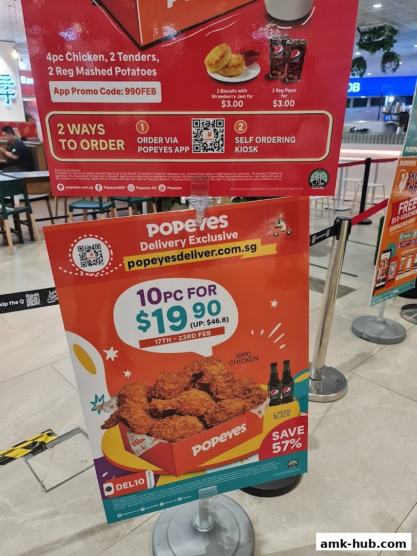 A promotional sign for Popeyes offering a 10-piece chicken deal and other combos.