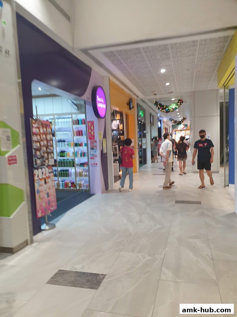 The exterior of the Beauty Language shop with shelves of products visible inside.
