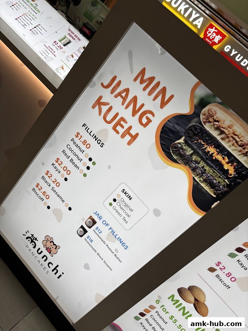A menu board for Munchi Pancakes featuring Min Jiang Kueh and other items.