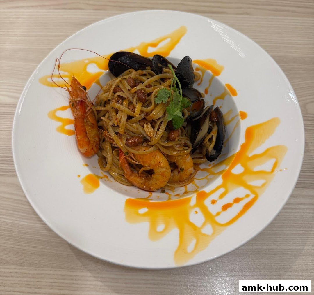A plate of linguine pasta with prawns and mussels, garnished with cilantro.