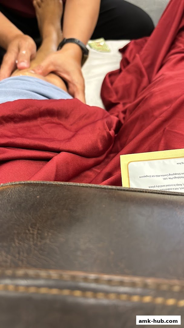 A person receiving a foot massage at a health and reflexology center.