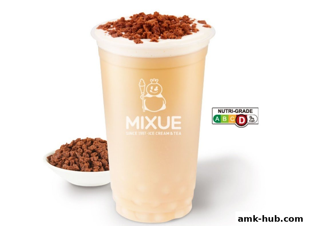 A creamy beverage with a topping of crushed cookies and a side of cookies.