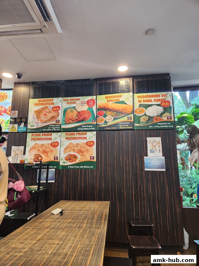 A wall display of various food promotions and menu items at Prata Raya.