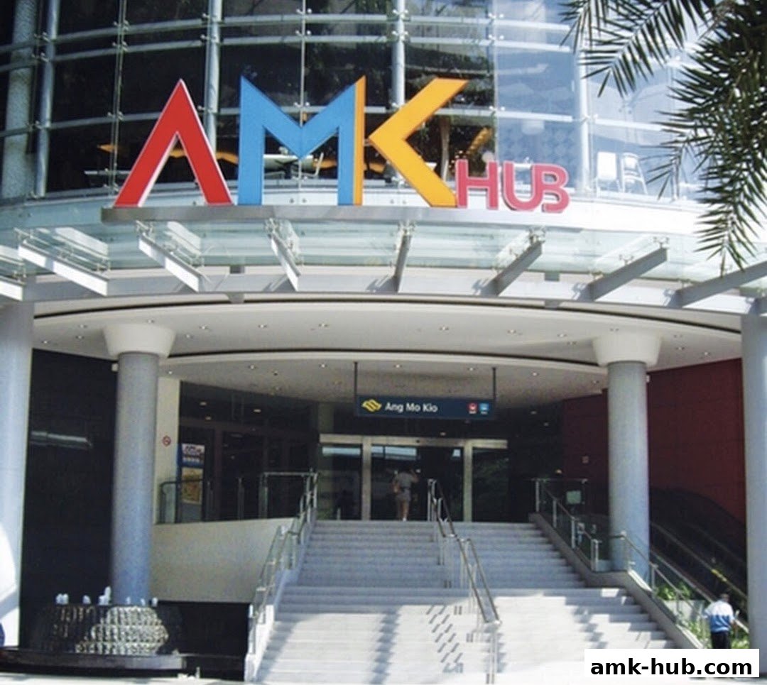The entrance of AMK Hub shopping mall with colorful signage and stairs leading up.