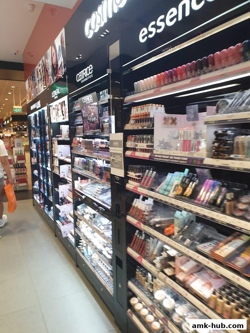 A wide selection of cosmetics and beauty products displayed on shelves in a retail store.