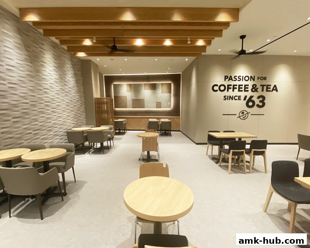Interior view of a modern coffee shop with ample seating and a prominent "Passion for Coffee & Tea" slogan.