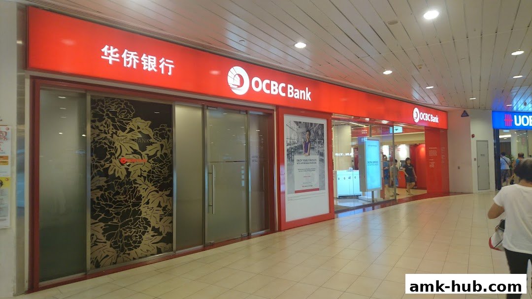 The exterior of an OCBC Bank branch with its signature red signage and glass doors.