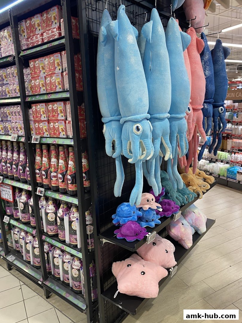 Shelves stocked with drinks and plush squid toys in various colors.