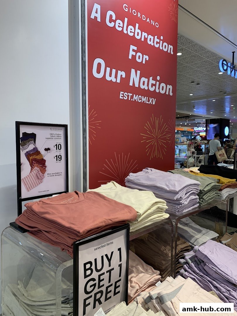 Giordano store display featuring colorful t-shirts and a 'Buy 1 Get 1 Free' promotion.