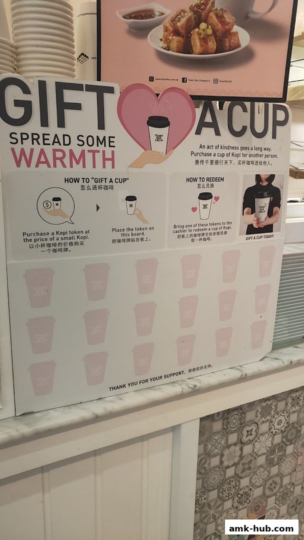 A sign explaining how to 'Gift a Cup' at Toast Box, with instructions and graphics.