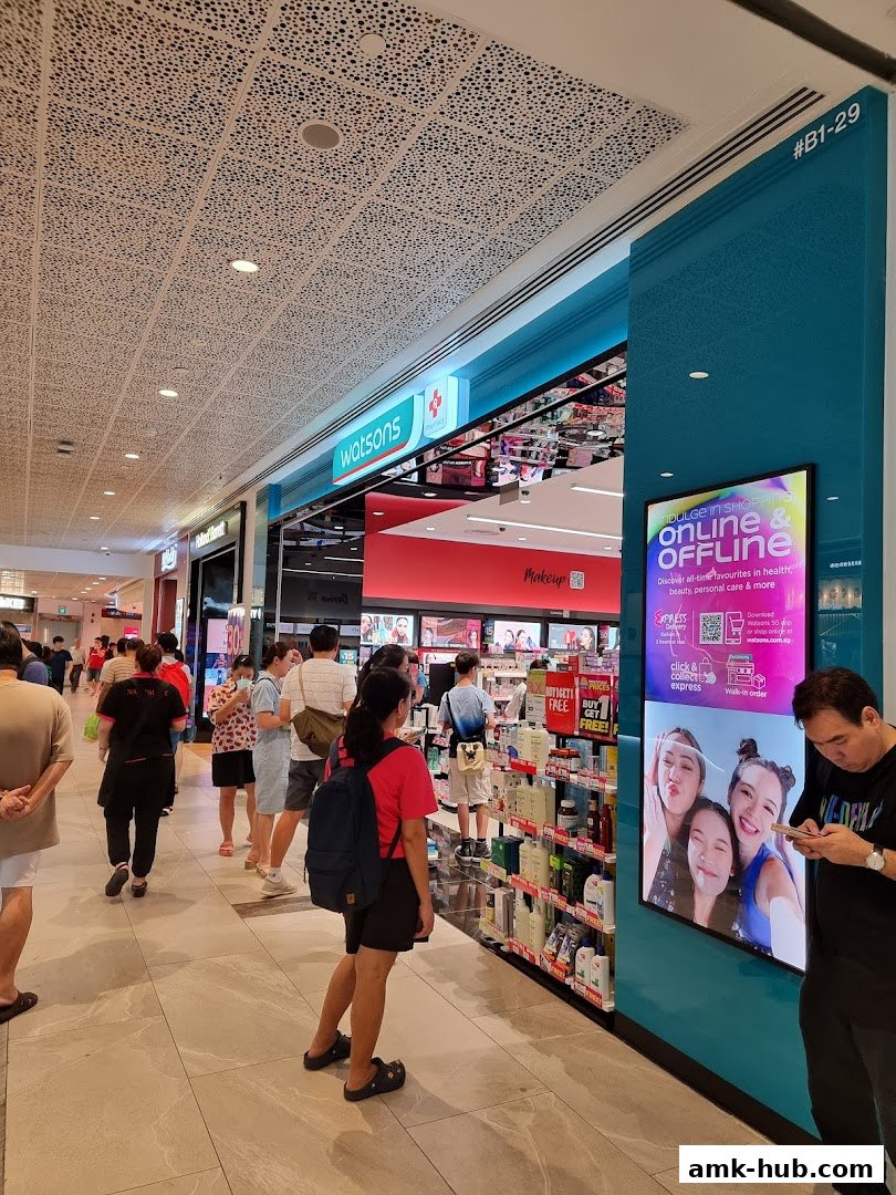 A Watsons store with a display promoting online and offline shopping, featuring beauty products.