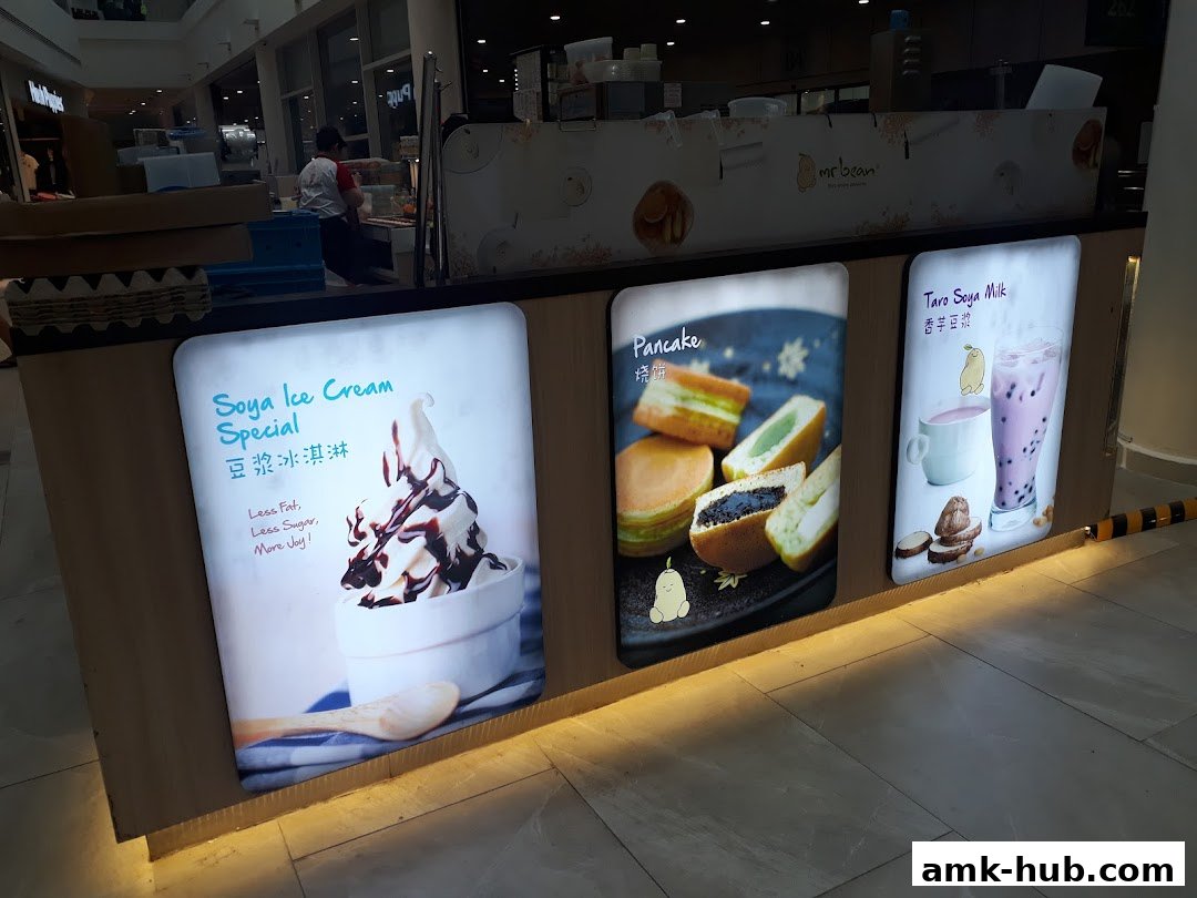 A display of food and drinks from the Mr Bean shop, featuring ice cream, pancakes, and milk tea.