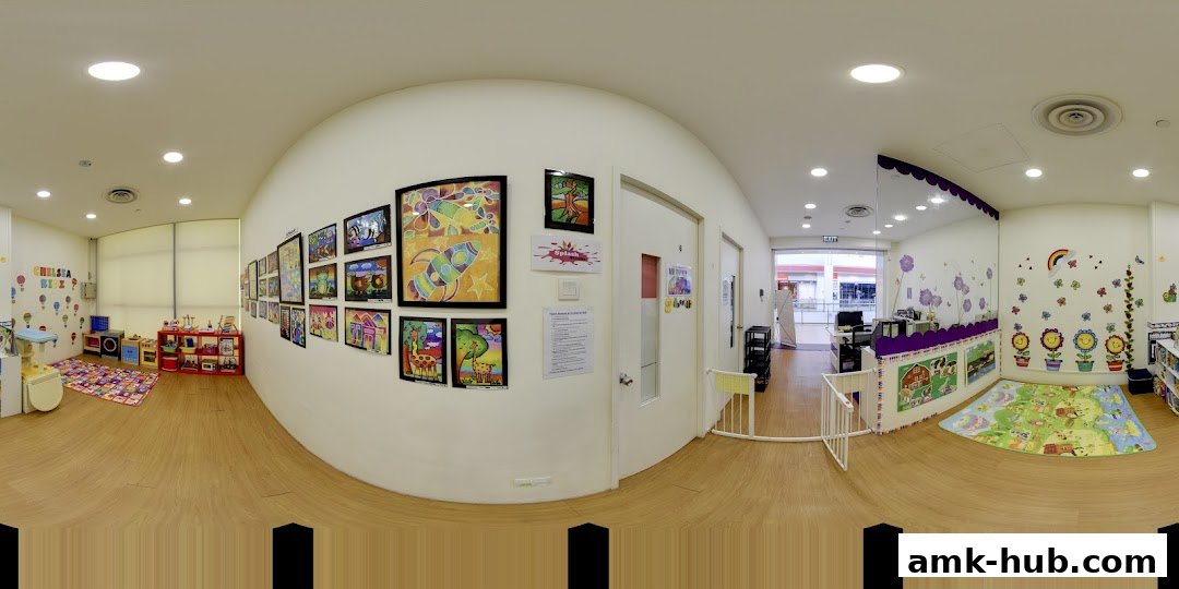Interior of a brightly decorated children's learning center with artwork and play areas.
