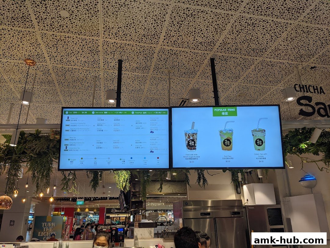 Digital menu boards displaying popular bubble tea drinks and customization options.
