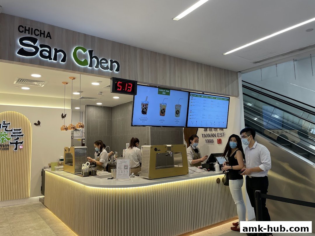 Customers ordering bubble tea at CHICHA San Chen with staff preparing drinks behind the counter.