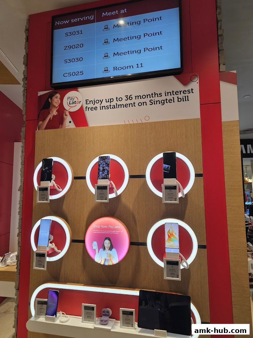 Singtel shop interior displaying phones and a 'Pay Later' promotion.