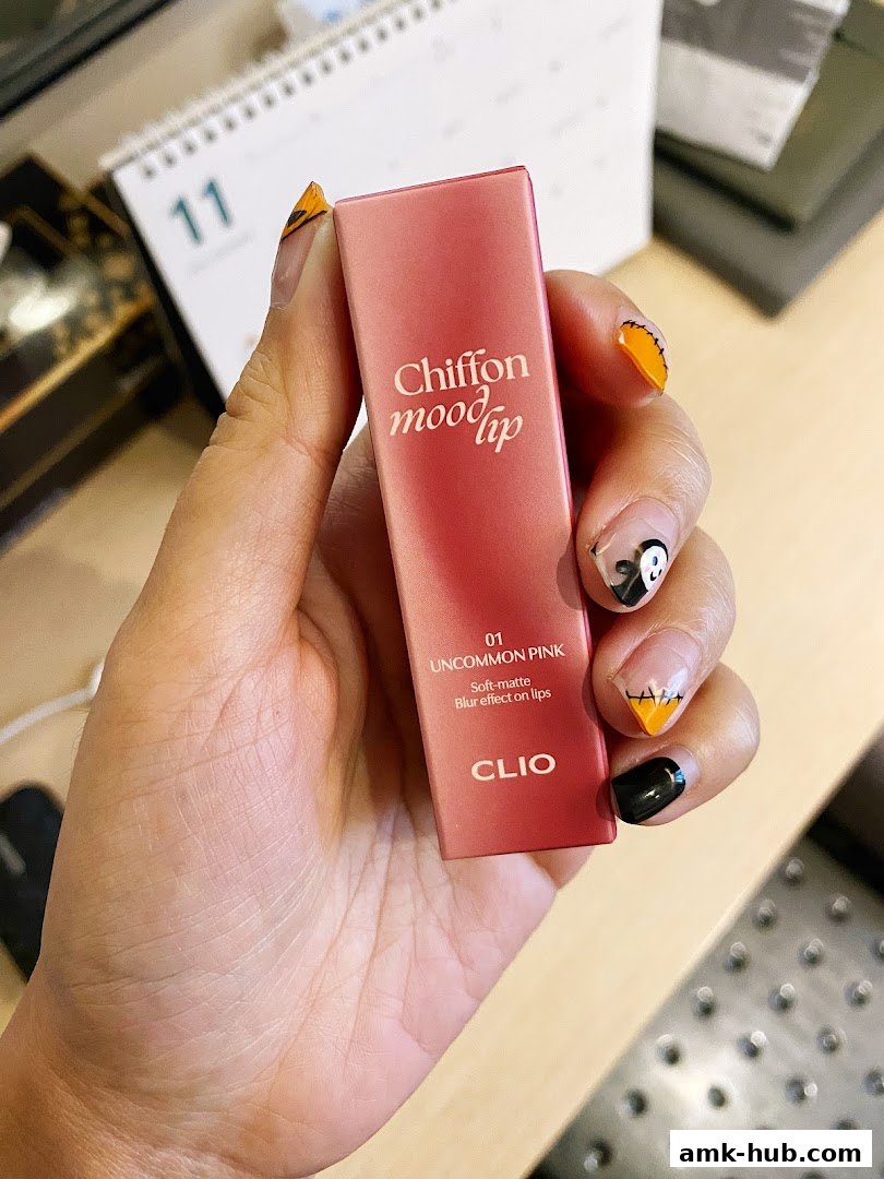 A hand holds a pink lipstick tube with 'Chiffon mood lip' branding.