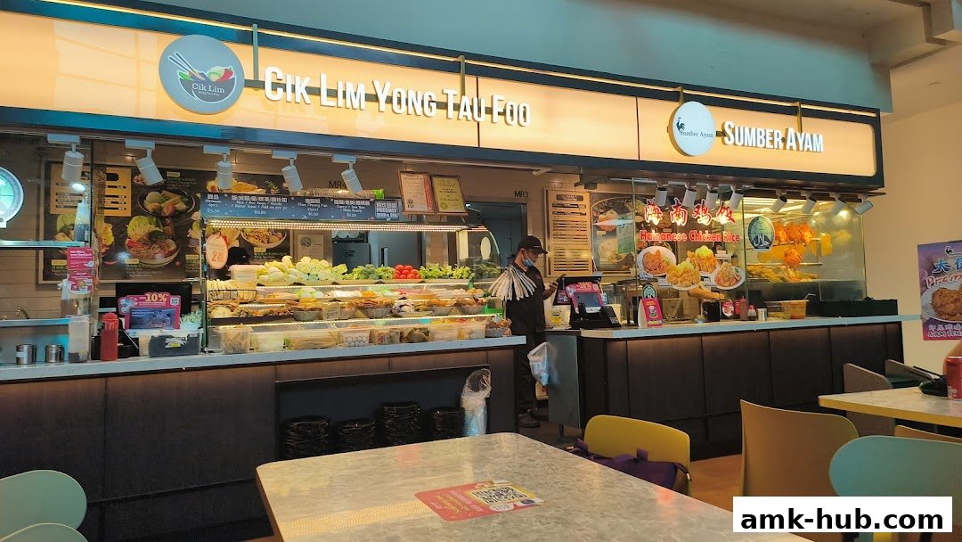 A food stall with a variety of ingredients displayed and a menu board.