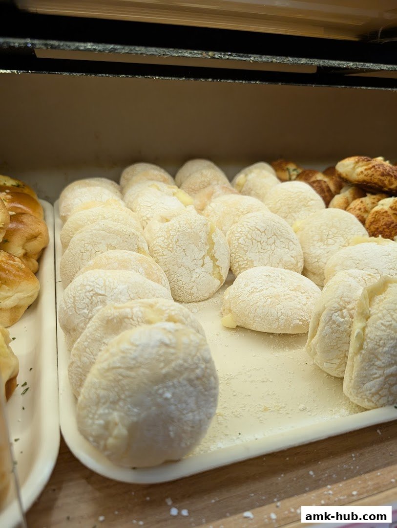 A close-up view of freshly baked bread rolls with a dusting of flour.