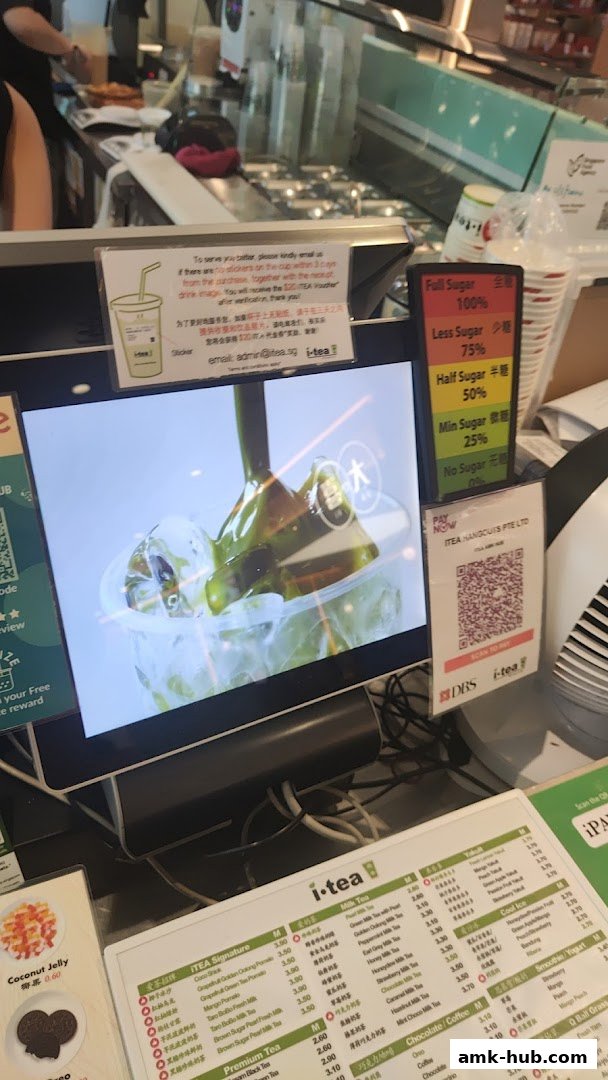 A counter display at iTEA showing a menu, payment options, and sugar level indicators.
