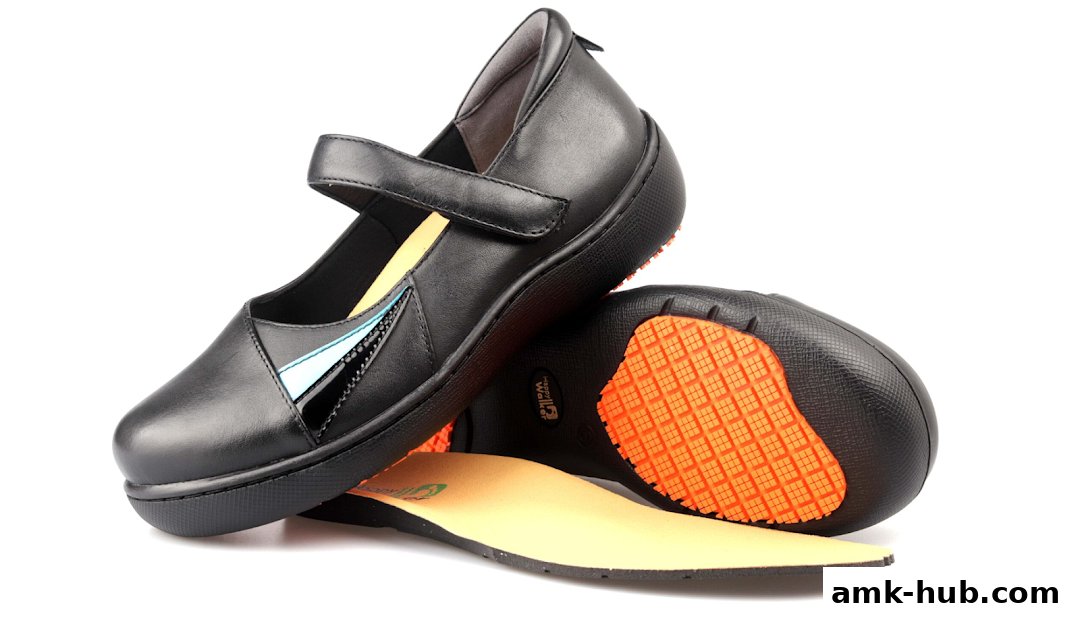 A pair of black Mary Jane style shoes with a velcro strap and a blue accent.