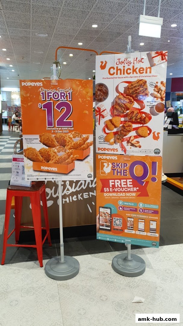 Popeyes promotional posters displaying opening specials and a free e-voucher offer.