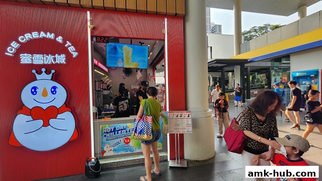 A MIXUE Ice Cream & Tea shop front with a large snowman logo and people ordering.