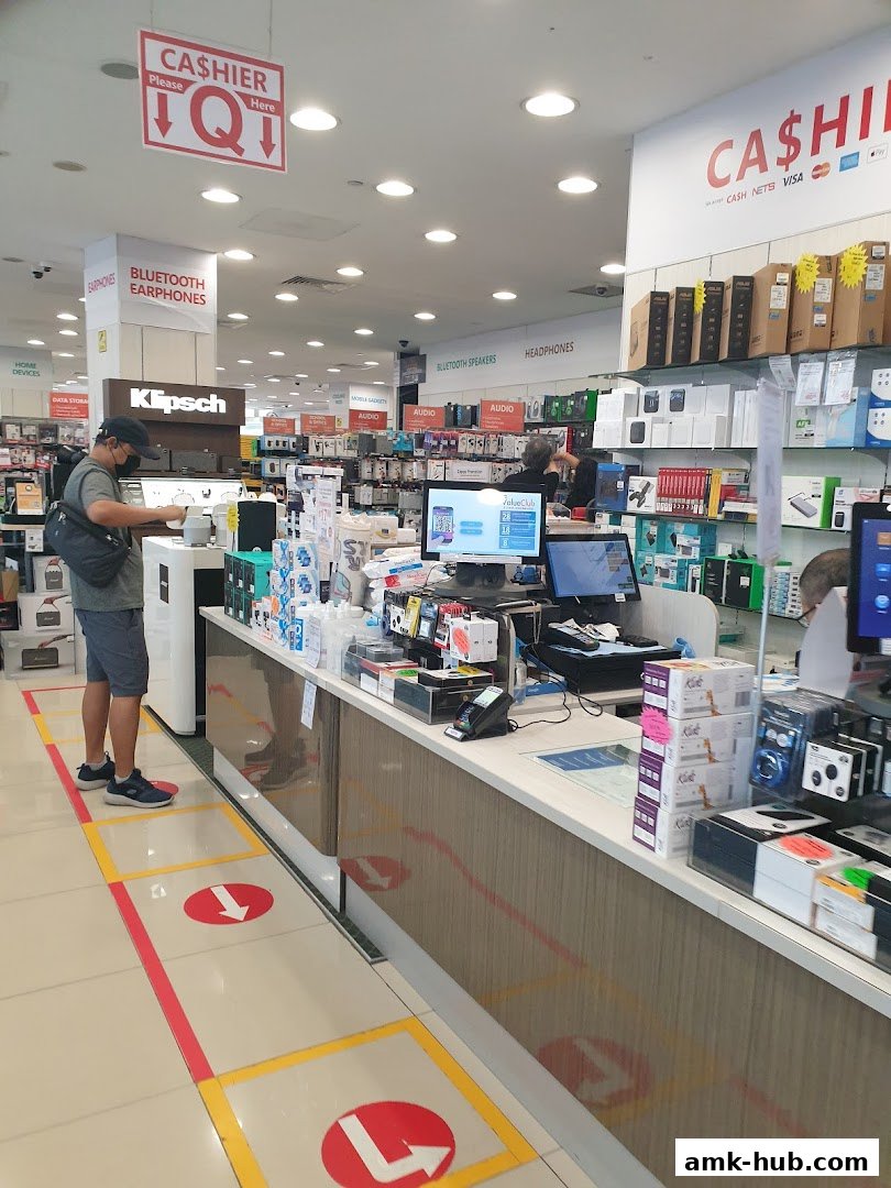 Interior view of a Challenger electronics store with a cashier counter and product displays.