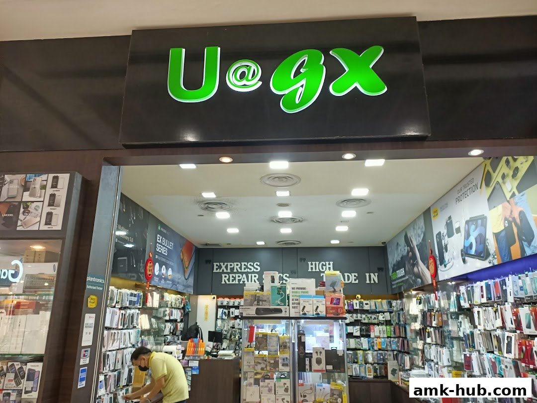 The entrance of a shop named UGX, selling mobile accessories and offering repair services.